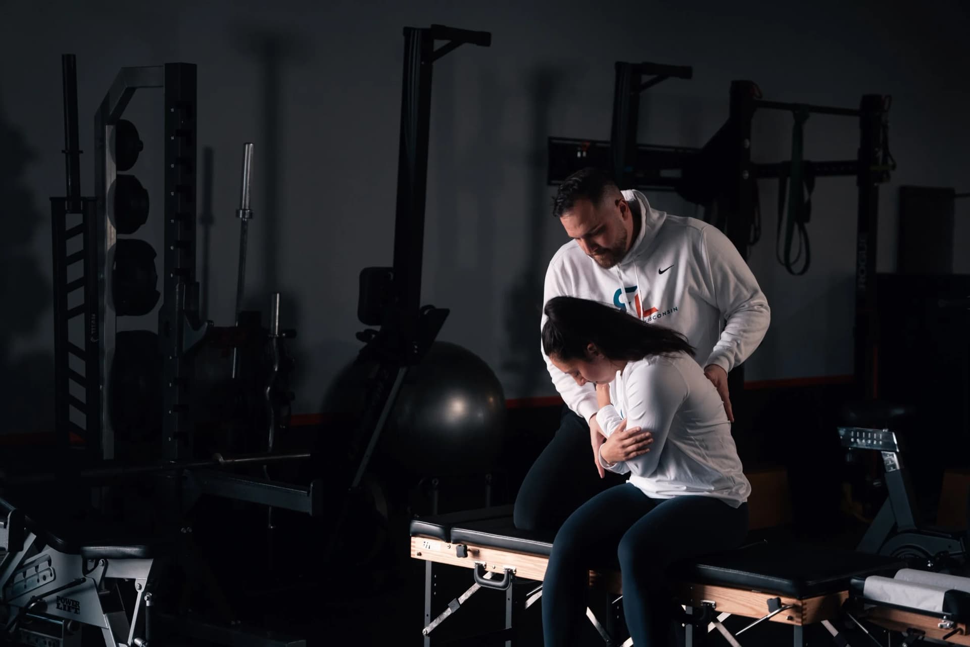 A Rehab Lab chiropractor treating a patient in the clinic gym